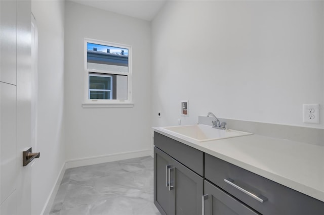 3024 Kensington Ave, Davenport, FL 33837 - washroom featuring hookup for an electric dryer, baseboards, washer hookup, marble finish floor, and a sink
