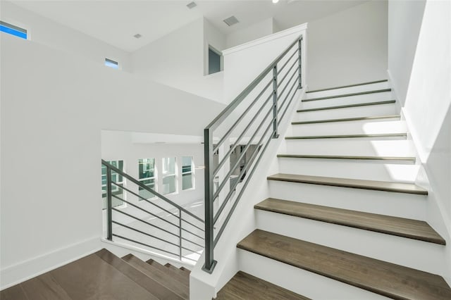 3024 Kensington Ave, Davenport, FL 33837 - staircase with visible vents, baseboards, and wood finished floors