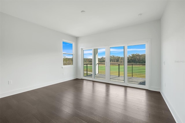 3024 Kensington Ave, Davenport, FL 33837 - empty room with dark wood-type flooring and baseboards