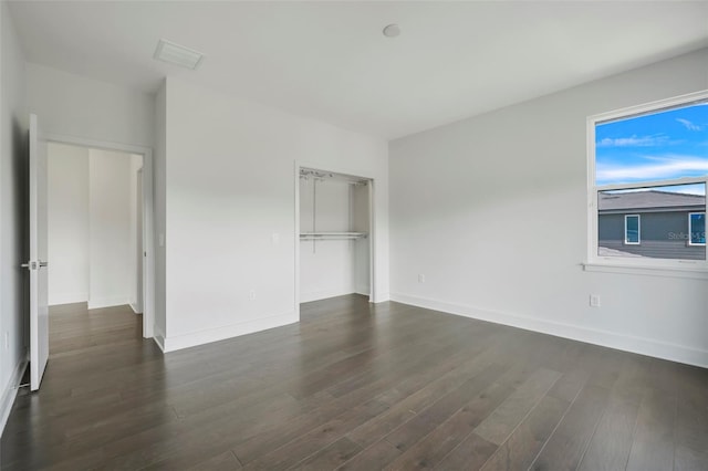 3024 Kensington Ave, Davenport, FL 33837 - unfurnished bedroom with a closet, baseboards, dark wood-style floors, and visible vents