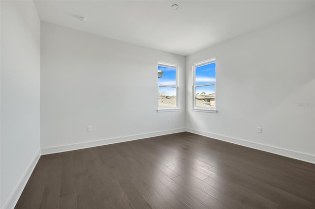 3024 Kensington Ave, Davenport, FL 33837 - empty room with dark wood-style flooring and baseboards