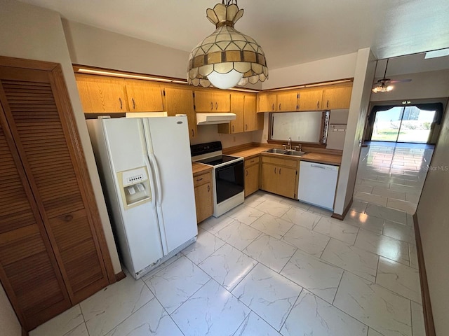 kitchen with marble finish floor, under cabinet range hood, light countertops, a sink, and white appliances