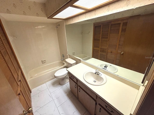 bathroom featuring marble finish floor, shower / bathtub combination, toilet, vanity, and a closet