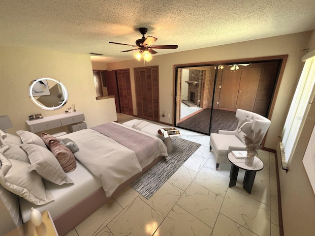 bedroom featuring marble finish floor, a ceiling fan, a textured ceiling, and visible vents