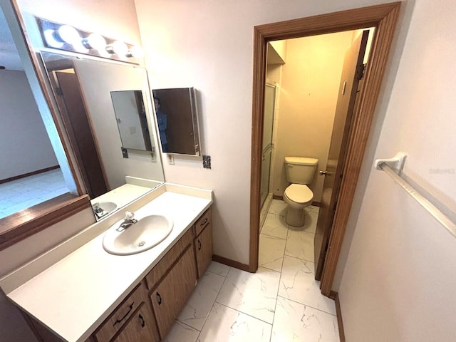 full bathroom with marble finish floor, a shower with door, toilet, vanity, and baseboards