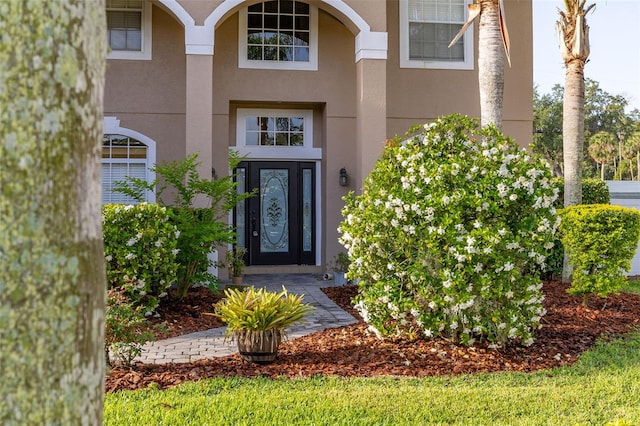 entrance to property with stucco siding
