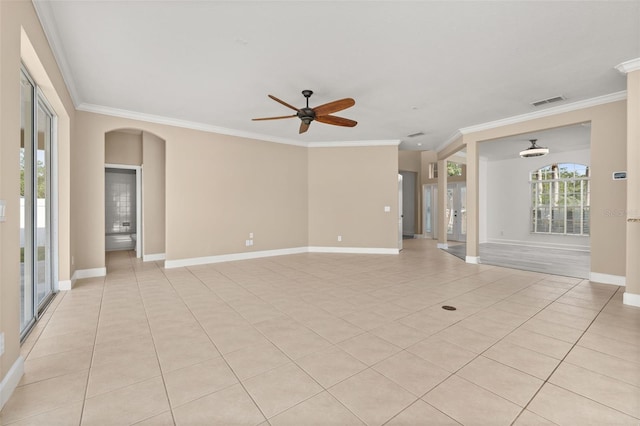 unfurnished living room featuring arched walkways, ceiling fan, light tile patterned flooring, and ornamental molding