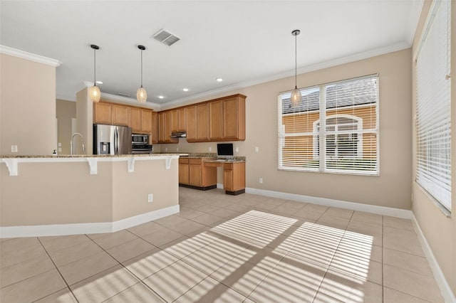 kitchen with appliances with stainless steel finishes, ornamental molding, a healthy amount of sunlight, and visible vents