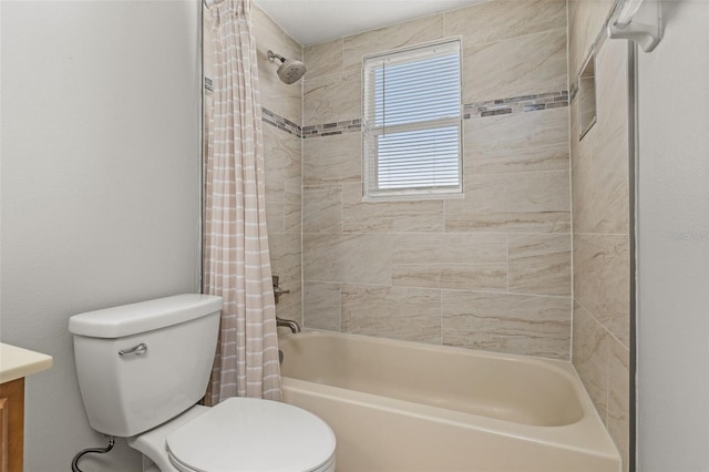 bathroom with vanity, shower / bath combo with shower curtain, and toilet