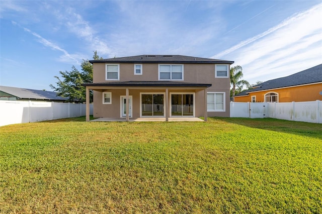 rear view of property featuring a fenced backyard, a patio, stucco siding, and a yard