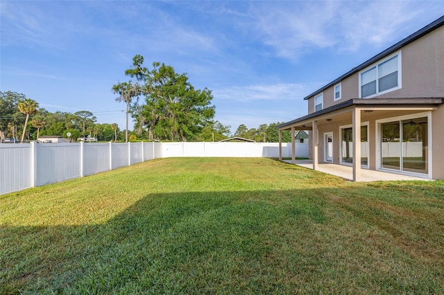 view of yard with a fenced backyard and a patio