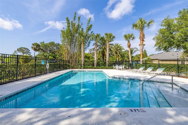 pool featuring fence and a patio area