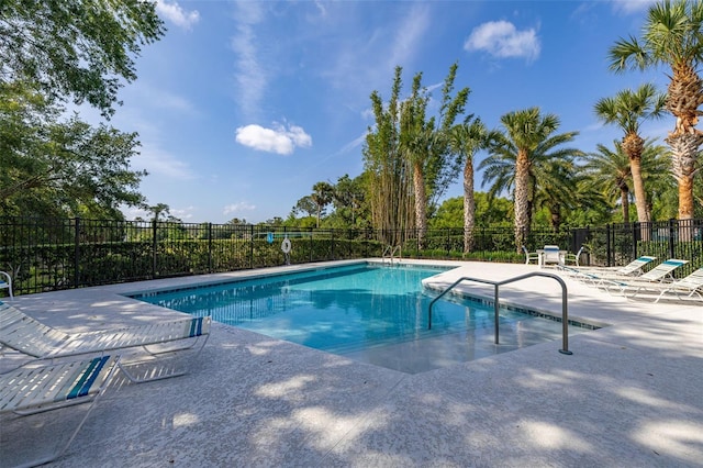 pool featuring fence and a patio