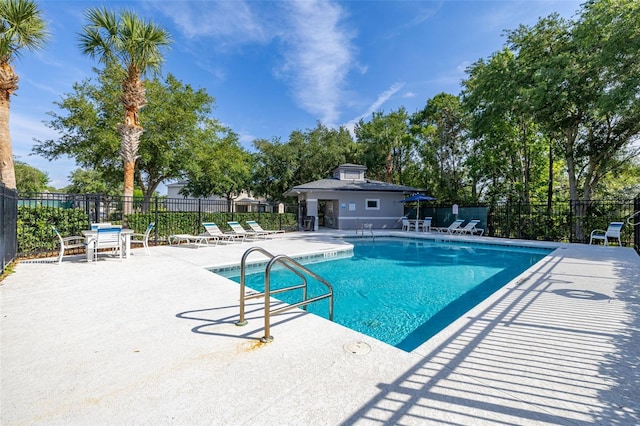 pool featuring a patio and fence