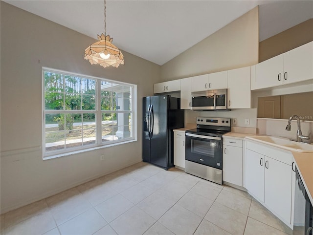 198 Bren Mar Ln, Palm Coast, FL 32137 - kitchen with vaulted ceiling, light countertops, white cabinets, stainless steel appliances, and a sink