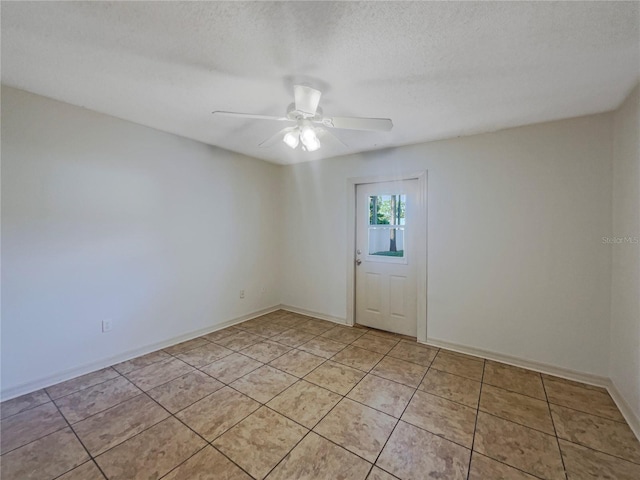 198 Bren Mar Ln, Palm Coast, FL 32137 - unfurnished room with a textured ceiling, light tile patterned floors, ceiling fan, and baseboards