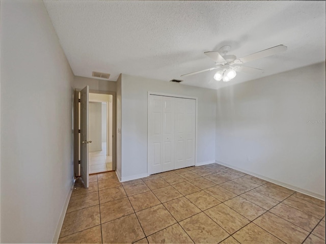 198 Bren Mar Ln, Palm Coast, FL 32137 - unfurnished bedroom with light tile patterned floors, visible vents, a textured ceiling, and baseboards