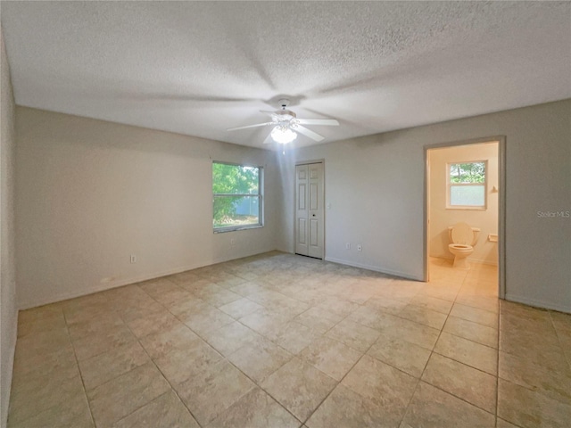 198 Bren Mar Ln, Palm Coast, FL 32137 - interior space with light tile patterned flooring, a textured ceiling, a healthy amount of sunlight, and ceiling fan