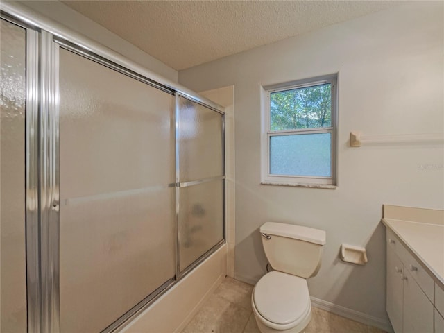 198 Bren Mar Ln, Palm Coast, FL 32137 - bathroom featuring a textured ceiling, vanity, toilet, bath / shower combo with glass door, and baseboards