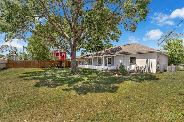 3205 Clewiston St, Deltona, FL 32738 - rear view of property featuring a sunroom, a yard, a fenced backyard, stucco siding, and a gate