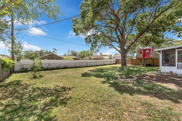 3205 Clewiston St, Deltona, FL 32738 - view of yard with a fenced backyard and a sunroom