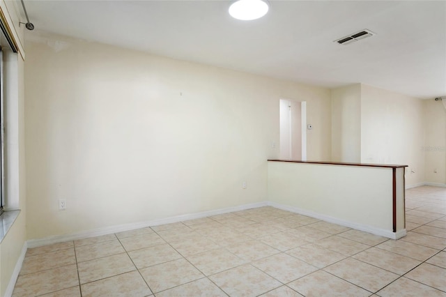 unfurnished room with light tile patterned floors and visible vents