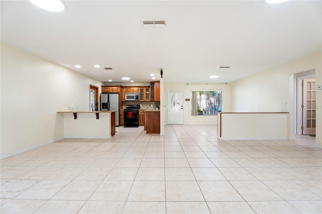 unfurnished living room with visible vents, recessed lighting, baseboards, and light tile patterned floors