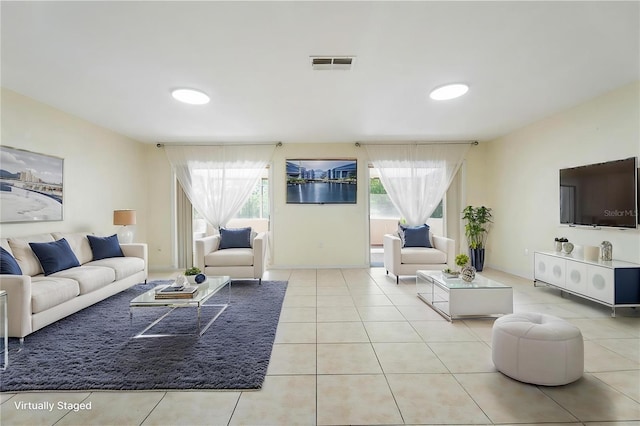 living area with tile patterned floors and visible vents
