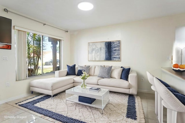 living area featuring baseboards and tile patterned flooring