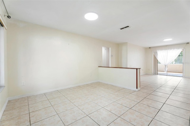 unfurnished room featuring visible vents, baseboards, and light tile patterned flooring