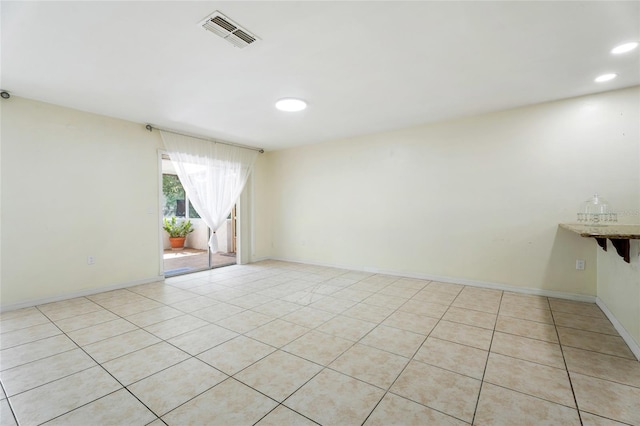 spare room with visible vents, recessed lighting, baseboards, and light tile patterned floors