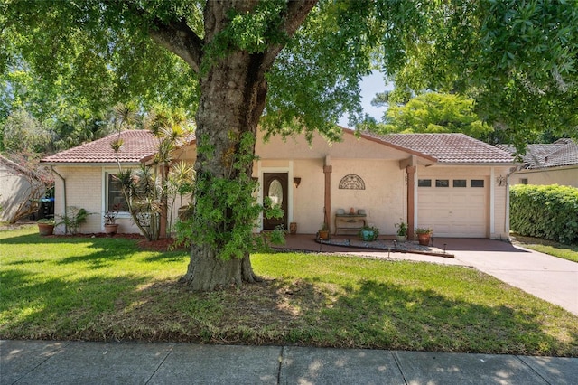 view of front of house with an attached garage, a front lawn, stucco siding, concrete driveway, and a tiled roof
