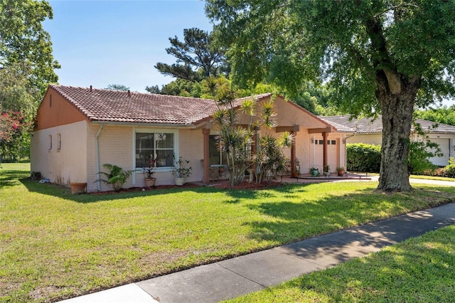 ranch-style house with an attached garage, stucco siding, a tiled roof, and a front yard