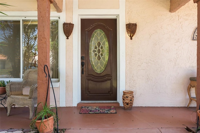 entrance to property featuring stucco siding