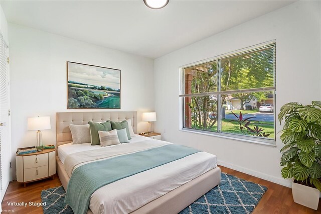 bedroom with baseboards and wood finished floors