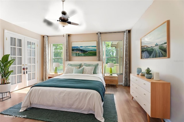 bedroom with french doors, a ceiling fan, and light wood finished floors