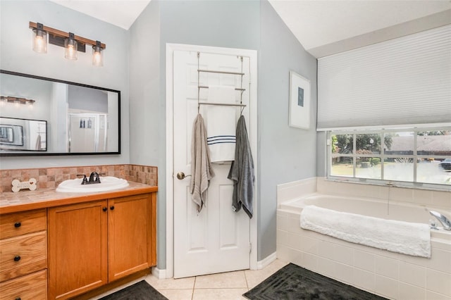 11506 Clair Pl, Clermont, FL 34711 - full bath with tile patterned flooring, vaulted ceiling, a bath, vanity, and baseboards