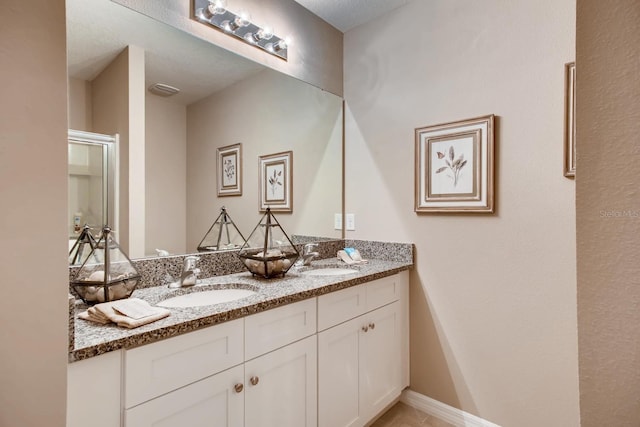 bathroom with a sink and double vanity