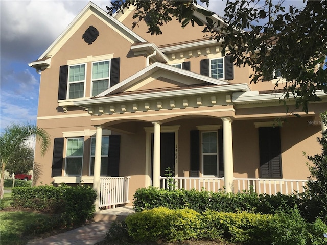 14841 Porter Rd, Winter Garden, FL 34787 - view of front facade featuring a porch and stucco siding