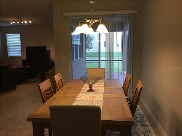 14841 Porter Rd, Winter Garden, FL 34787 - dining room featuring baseboards and an inviting chandelier