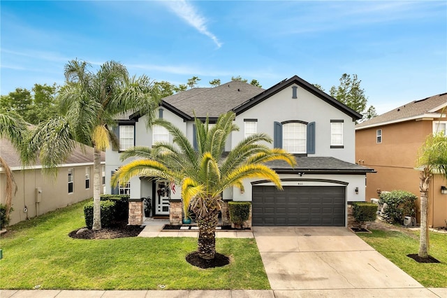 view of front of home featuring concrete driveway, a front yard, stucco siding, and a garage