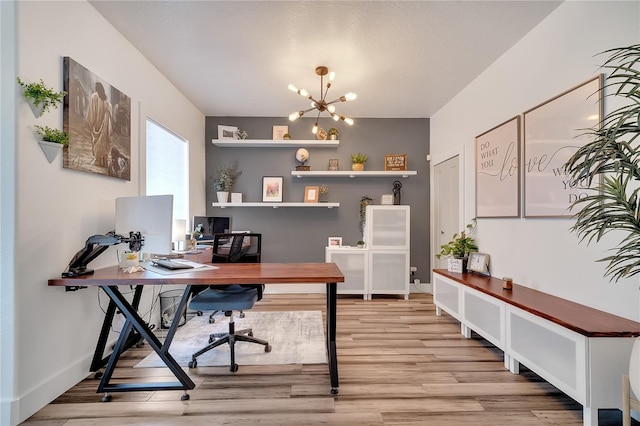 home office with a chandelier, light wood-style flooring, and baseboards