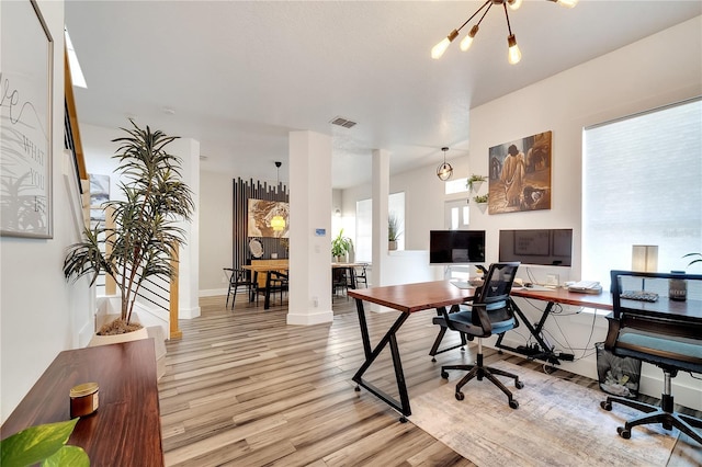 home office with baseboards, visible vents, and light wood-style flooring