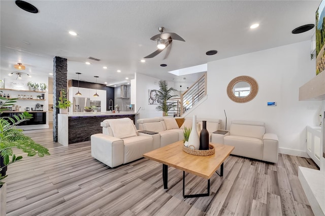 living room with visible vents, ceiling fan, recessed lighting, and light wood-style flooring