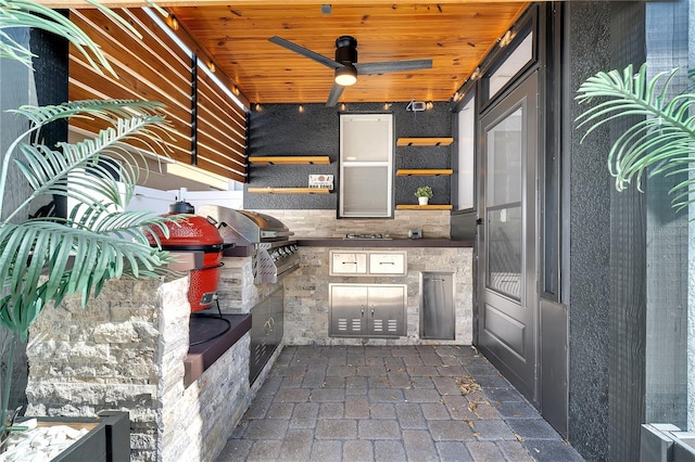 view of patio featuring ceiling fan and an outdoor kitchen