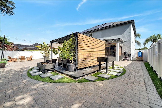 rear view of property with a patio, a fenced backyard, and a wooden deck