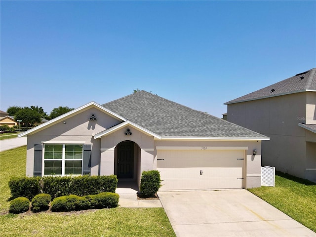 3702 Maidencain St, Clermont, FL 34714 - ranch-style house featuring an attached garage, concrete driveway, a front lawn, stucco siding, and roof with shingles