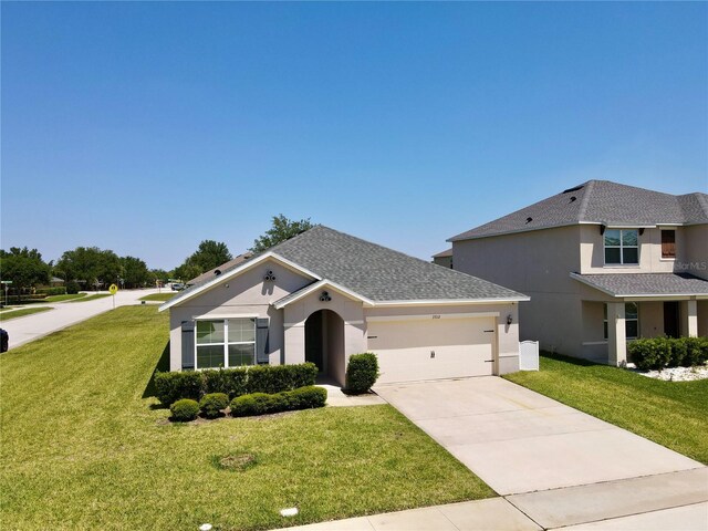 3702 Maidencain St, Clermont, FL 34714 - view of front of home with a garage, stucco siding, concrete driveway, and a front yard