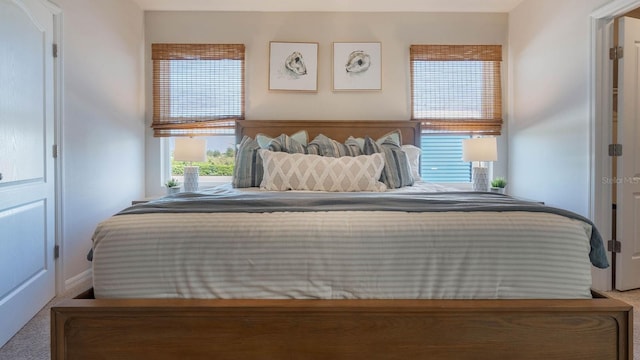 bedroom featuring baseboards and carpet floors