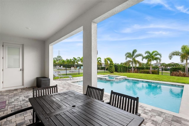 416 Southfield St, Kissimmee, FL 34747 - exterior space with a patio area, a fenced backyard, a pool with connected hot tub, and outdoor dining area